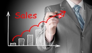 business man drawing graph of sales